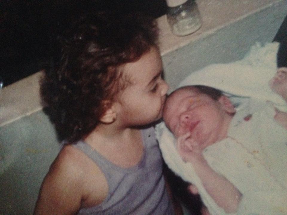My lovely sister Ruthy kissing me (the red baldish baby). She has always been a lovely representation of kindness in my life. 